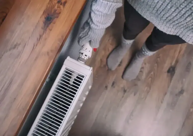 Socks warming over a floor vent in a Louisville home