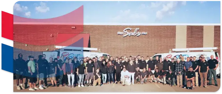 The Sal's team in front of the shop with the vans